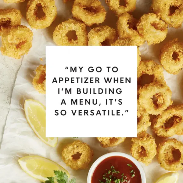Overhead view of breaded calamari rings with white box text overlay that reads "My go to appetizer when I'm building a menu. It's so versatile."