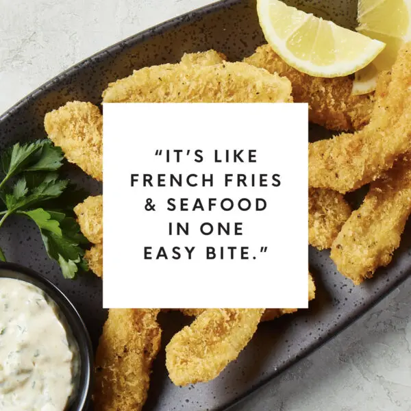 Overhead view of calamari fries with white box text overlay that reads "It's like french fries & seafood in one easy bite."