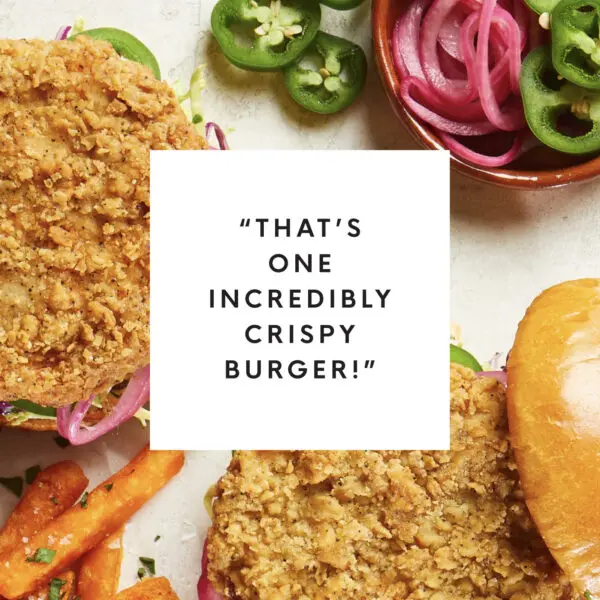 Overhead view of crispy shrimp burgers with white box text overlay that reads "That's one incredibly crispy burger!"