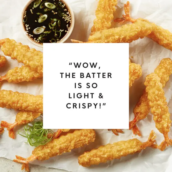 Overhead view of tempura battered shrimp with white box text overlay that reads "Wow, the batter is so light & crispy!"