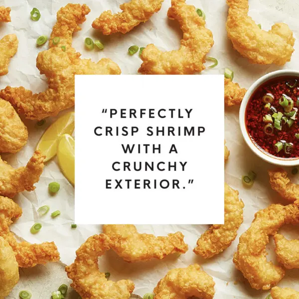 Overhead view of Social Kitchens Professional Crispy Battered Shrimp with white box text overlay that reads "Perfectly crisp shrimp with a crunchy exterior."