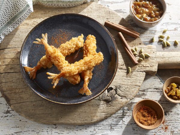 Harissa Dusted Tempura Shrimp plated on wooden board