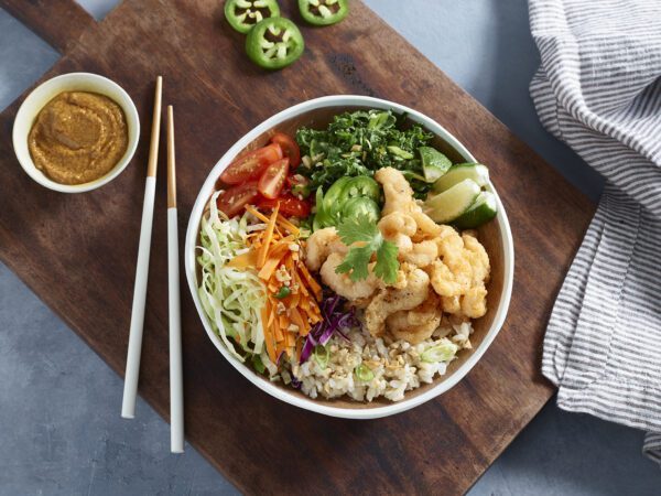 Corkscrew Shrimp Buddha Bowl on cutting board with chopsticks