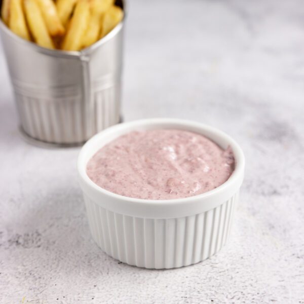 Kalmata Aioli in a white ceramic bowl with a side of french fries